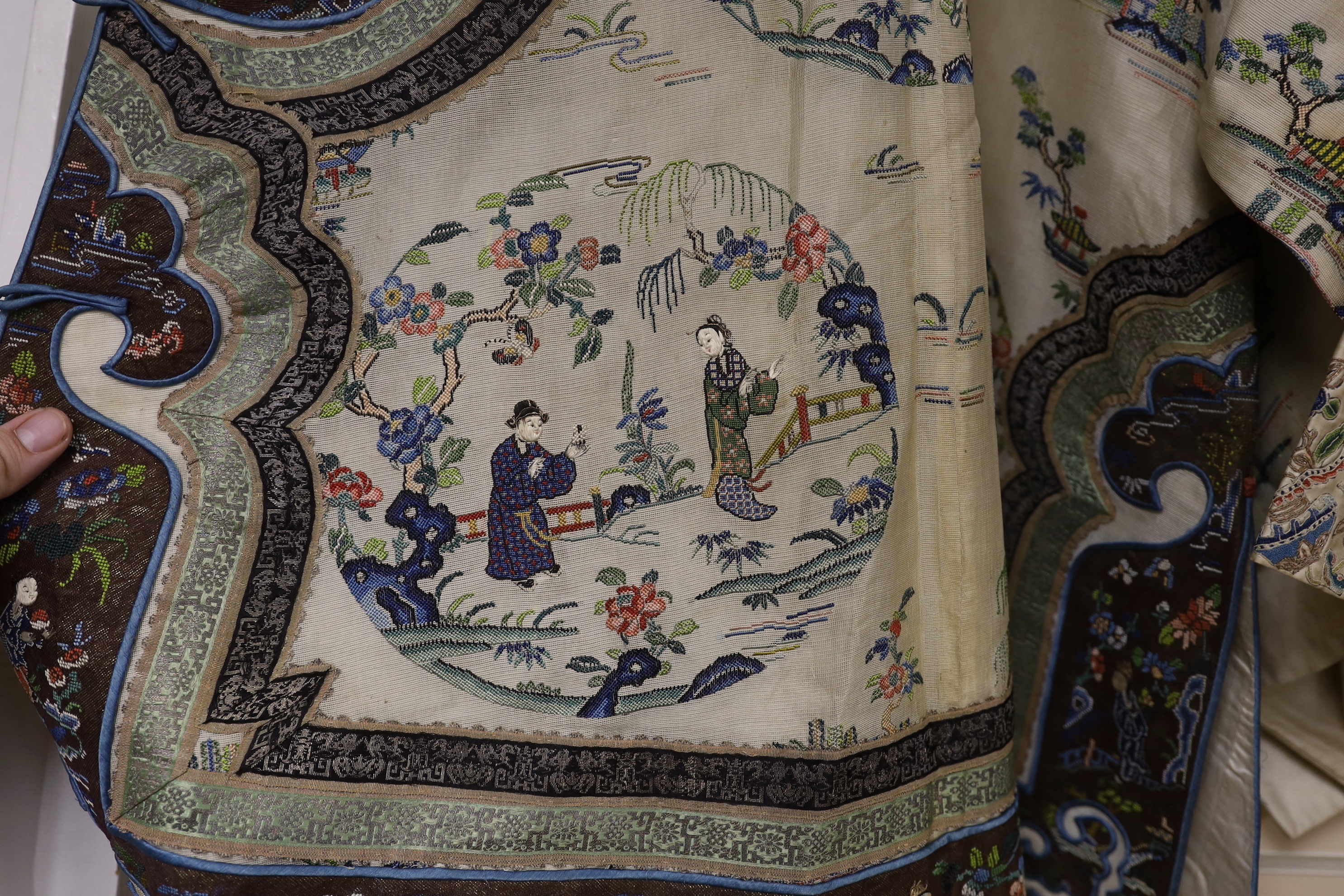 A late 19th/early 20th century Chinese gauze summer robe embroidered with flowers, figures and pagodas, 85cm high